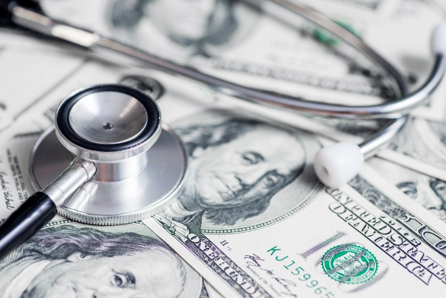 Stethoscope on the dollars. Medical costs. Healthcare payment concept. Concept of analysis of the market and economy and interest rates Image illustrating healthcare costs