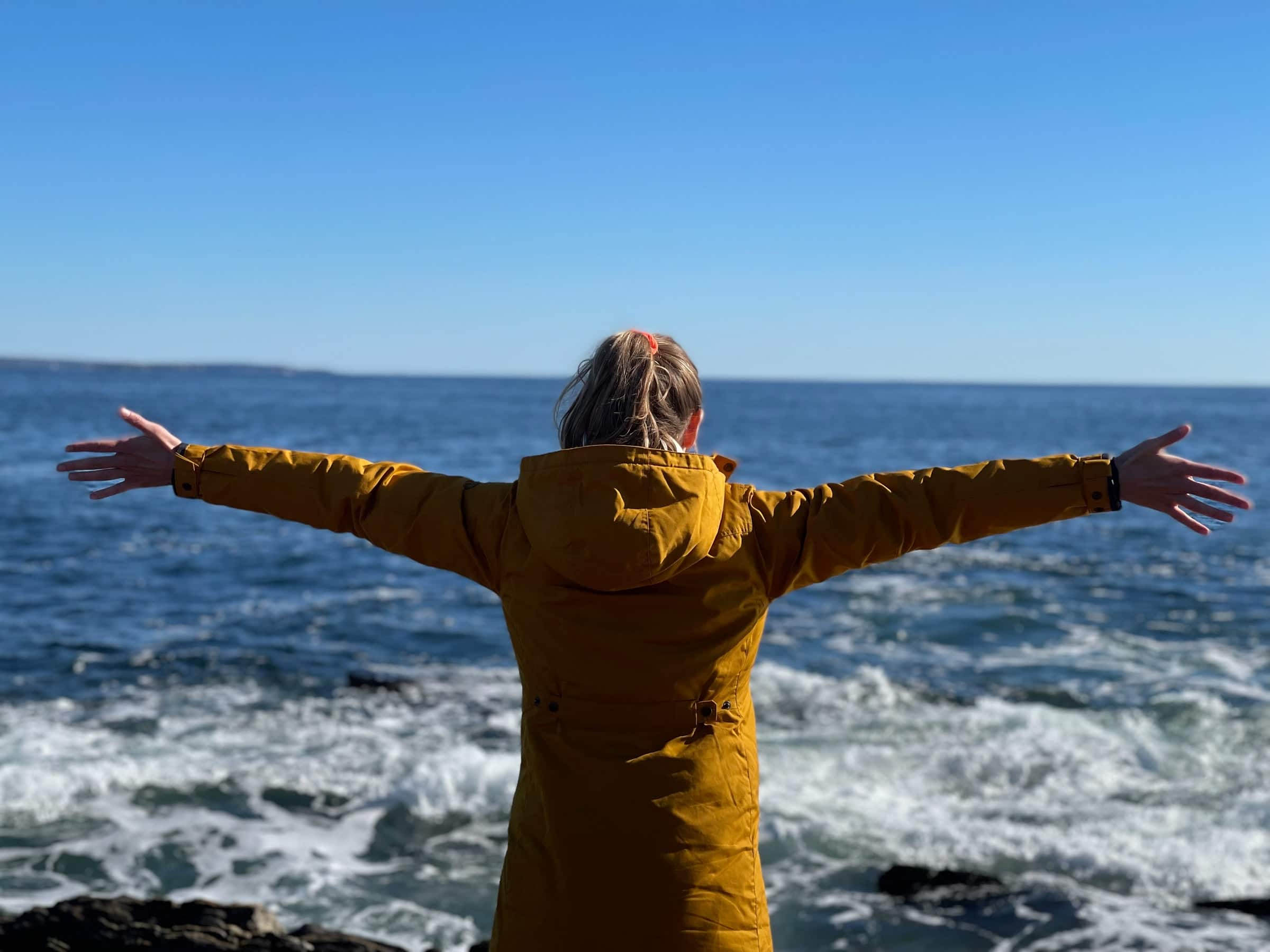 Photo of woman feeling freedom at the ocean
