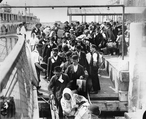 disembarking-ellis-island Immigrants disembark at Ellis Island