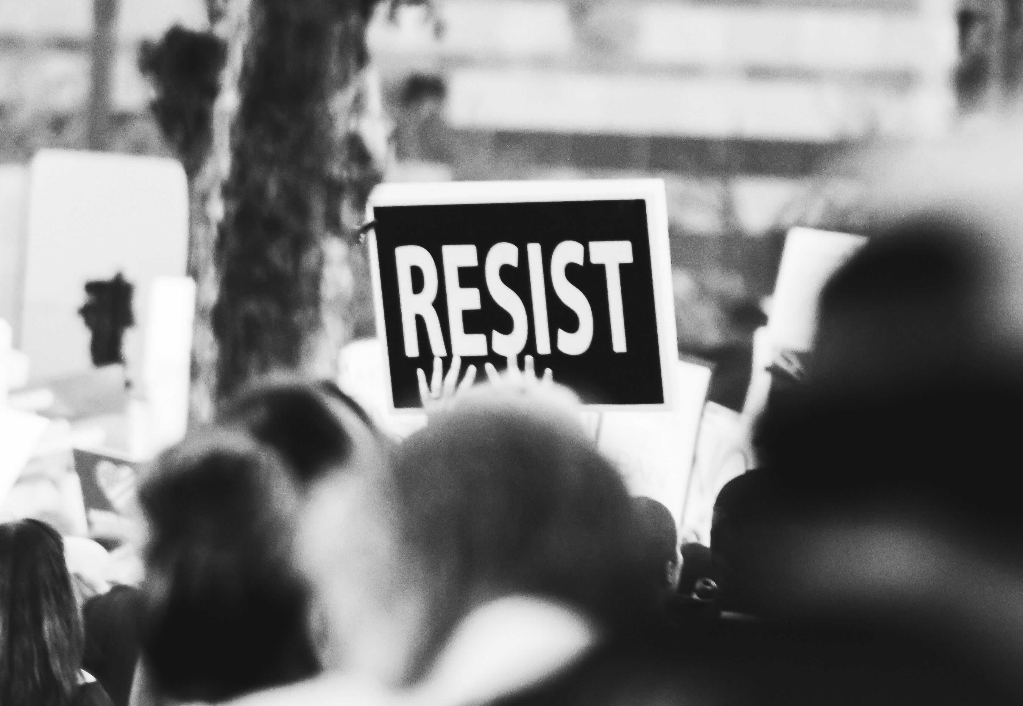 Marcher holding sign that says "Resist"