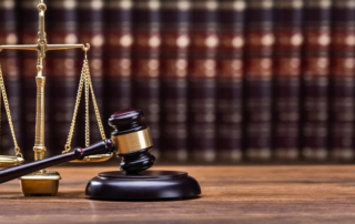 Photo of a gavel in front of the scales of justice
