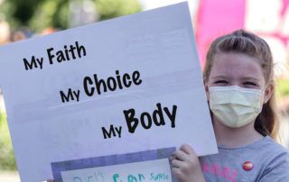 Girl holding sign that says, "My Faith, My Choice, My Body"