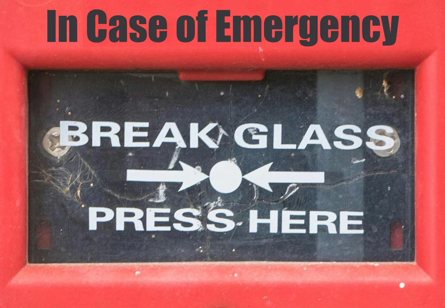 Image of an alarm that reads, "In case of emergency, break glass. Press here."
