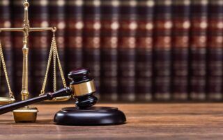 Photo of a gavel in front of the scales of justice