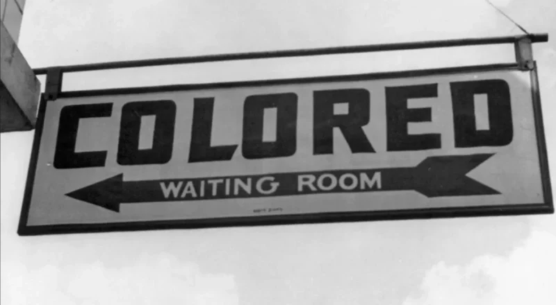 Sign points to "Colored Waiting Room"