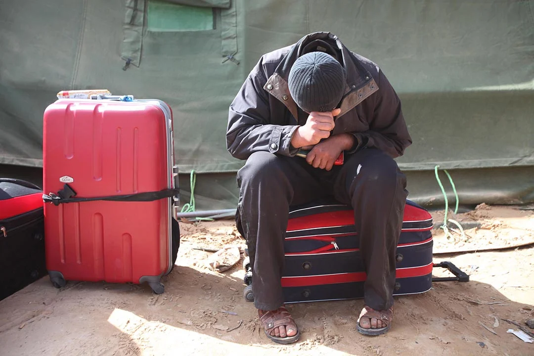 IIRIRA-PRWORA Immigrant with head resting on his hands